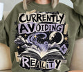 Crewneck graphic sweatshirt, “Currently Avoiding Reality” galaxy text and stars
