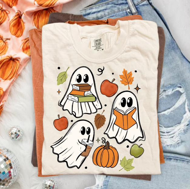 White short-sleeve graphic tee with reading ghosts, pumpkins, and autumn leaves print
