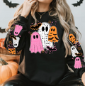 Black graphic tee with pink and orange dotty ghosts, bats, and stars