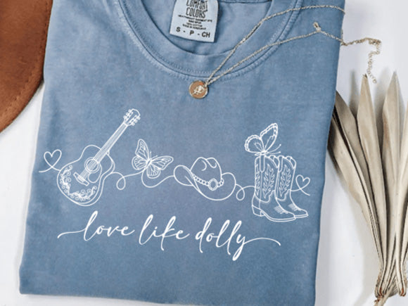 Light blue graphic tee with guitar, cowgirl, and butterflies; cursive 'Love life dolly' print