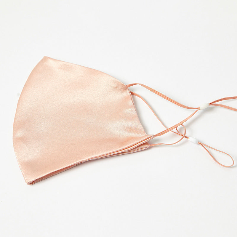 Peach silk face mask with pleated front and orange drawstring ties