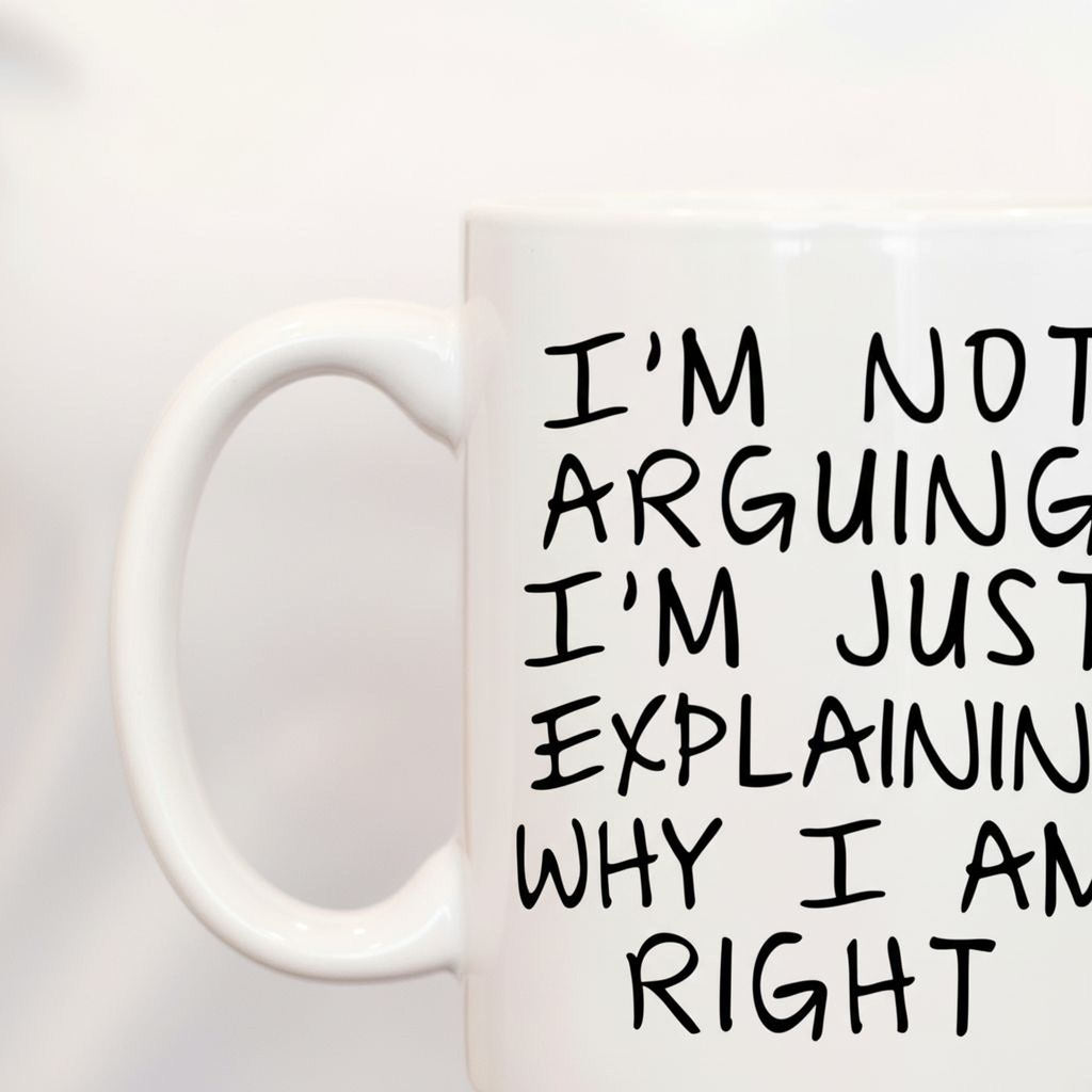Close-up of white ceramic coffee mug with black quote text