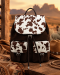 Brown cow print backpack handbag with front flap, twin buckled pockets and adjustable straps