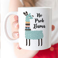 White ceramic coffee mug with cute teal llama and “No Prob Llama” text