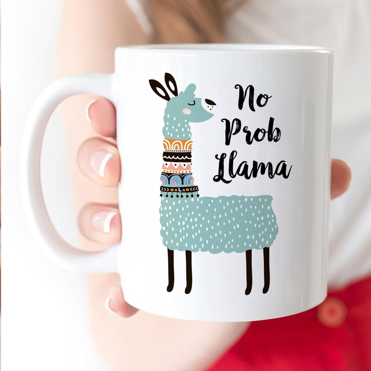 White ceramic coffee mug with cute teal llama and “No Prob Llama” text