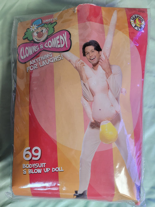 Inflatable blow-up doll in white bodysuit holding yellow inflatable, in retail package