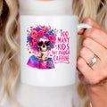 White ceramic mug with colorful floral crown skull and pink “Too Many Kids” text, right handle.
