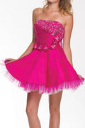 Fuchsia strapless A-line dress with sequin bodice, rosette detail and tulle hem