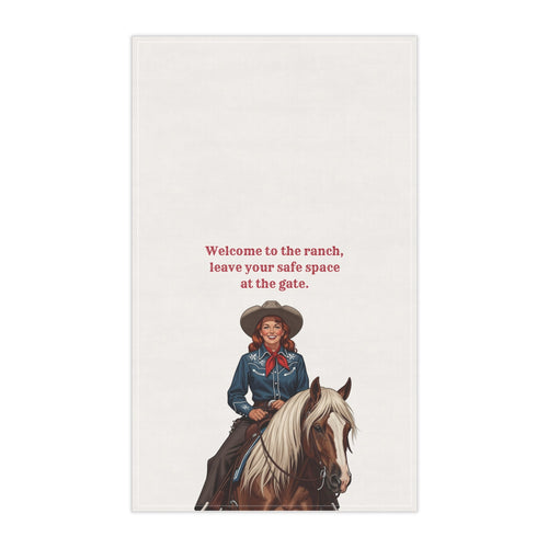 Off-white tea towel with blue cowgirl illustration and ranch welcome text