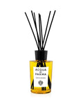 Room diffuser with amber glass bottle, black reed sticks, and branded label