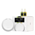 Smart fragrance diffuser set with two white circular diffusers and two scent cartridges in a box