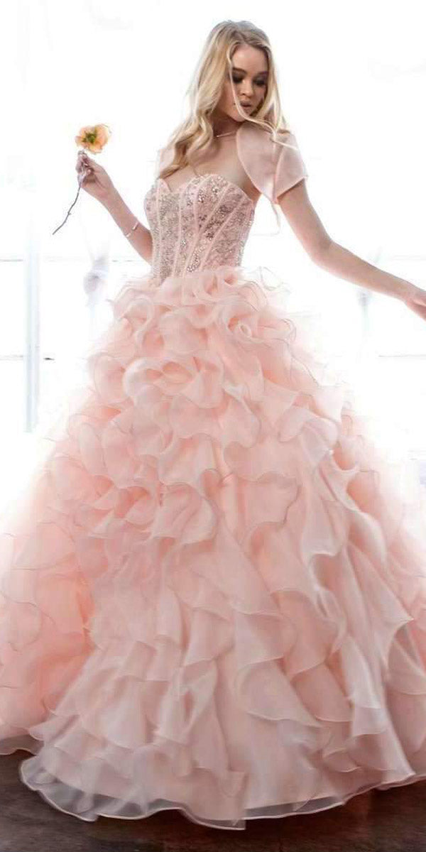 Light pink strapless ball gown with beaded corset bodice and layered organza ruffle skirt