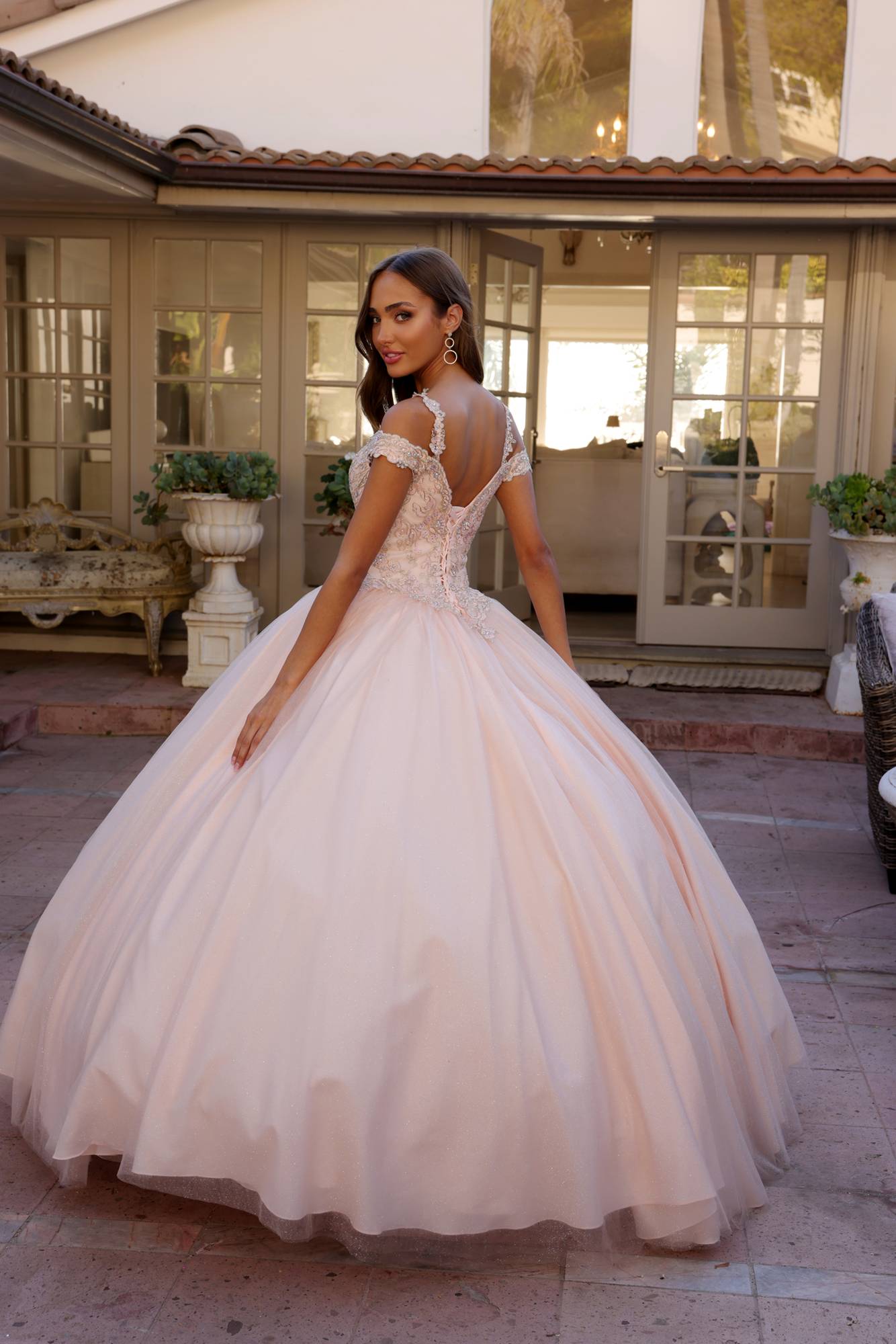 Light pink corset-style off-shoulder ball gown with tulle skirt and lace appliques