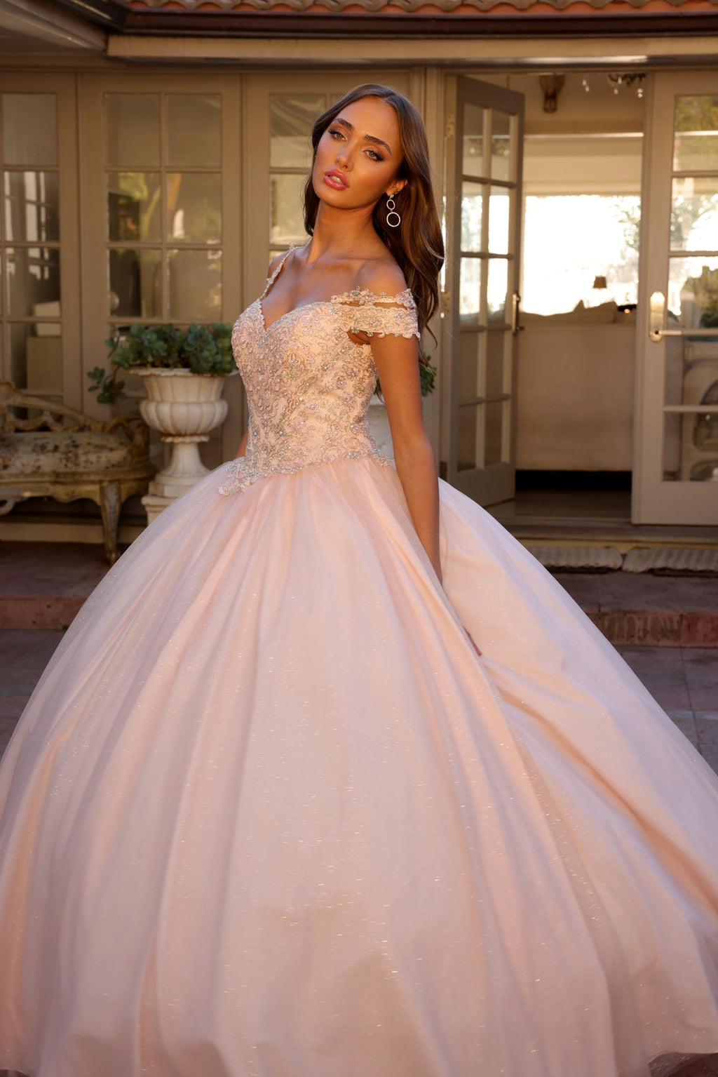 Light pink off-shoulder ball gown with glitter lace bodice and flowing tulle skirt