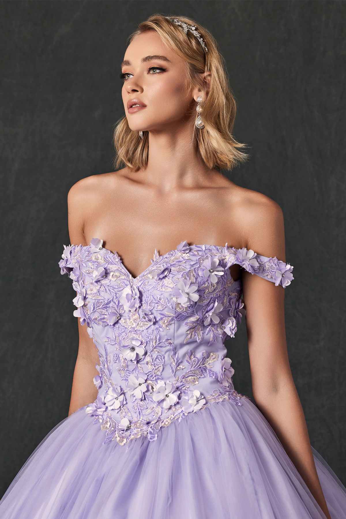 Lilac quinceanera ball gown close-up with off-shoulder ruffled bodice and 3D floral appliques