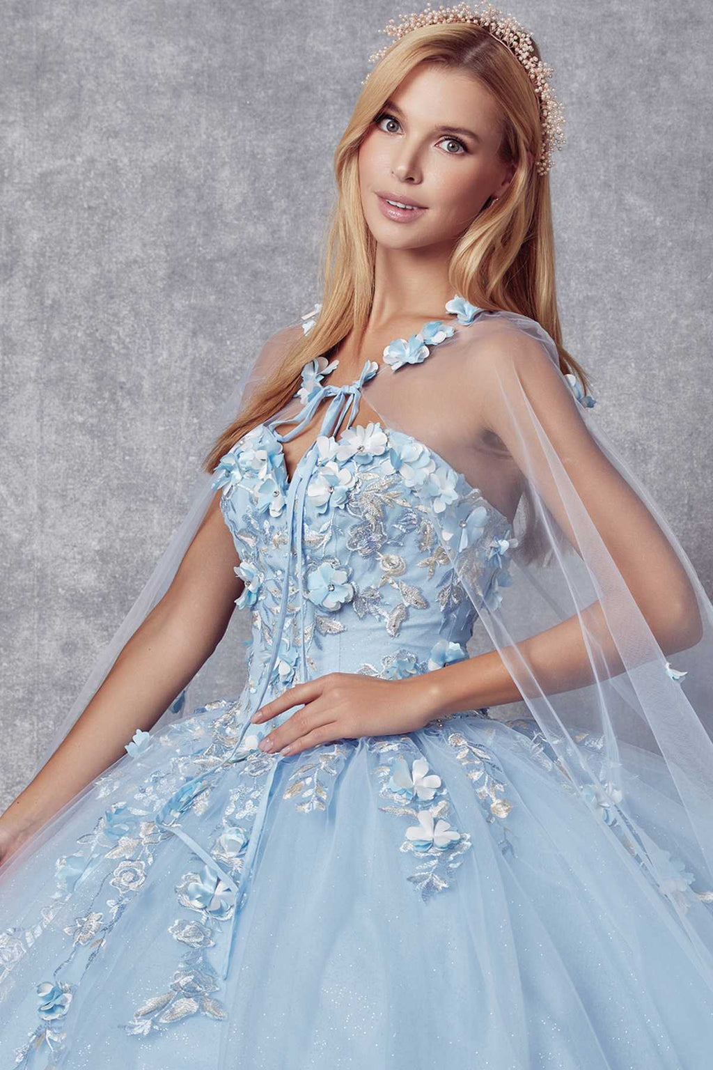 Light blue A-line ball gown with illusion straps, floral appliqué, and tulle skirt