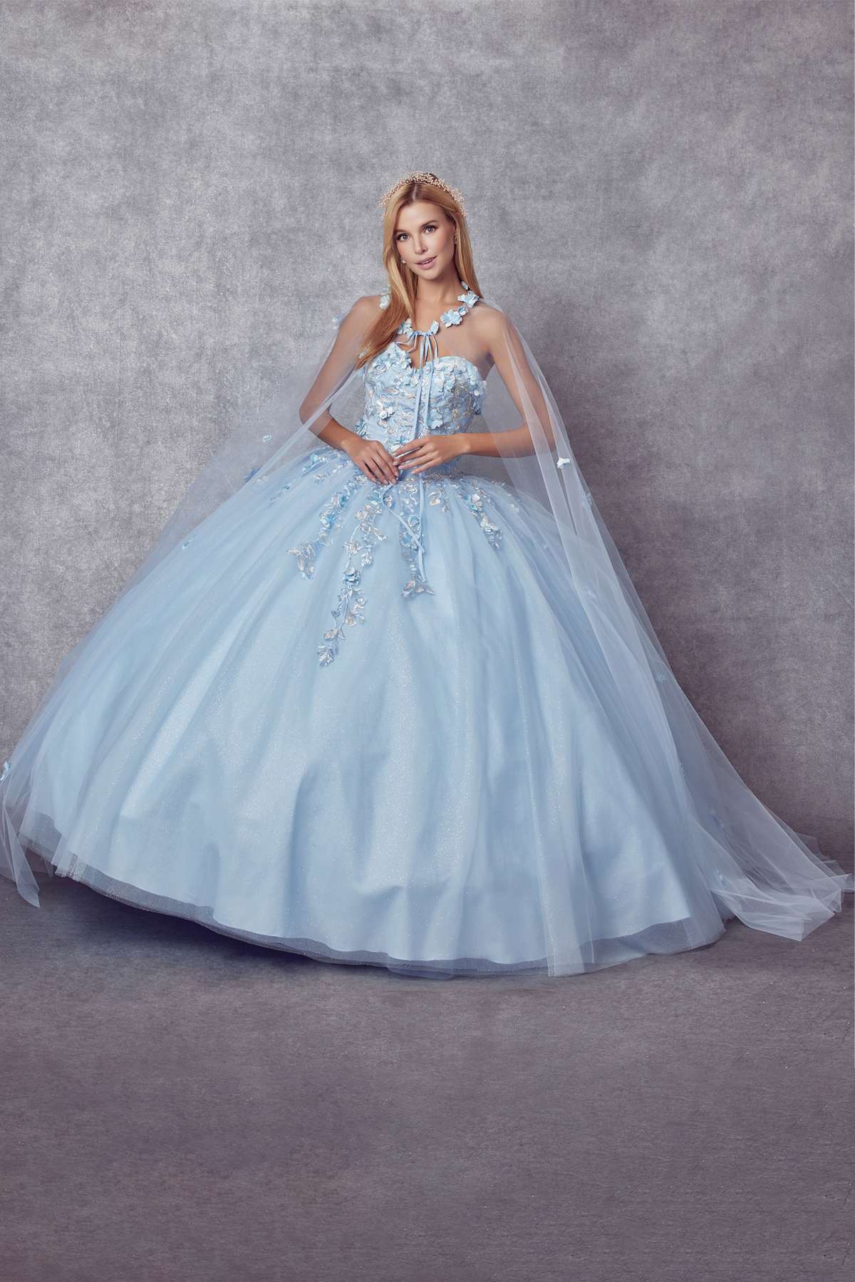 Light blue A-line ball gown with embroidered floral accents and flowing tulle skirt