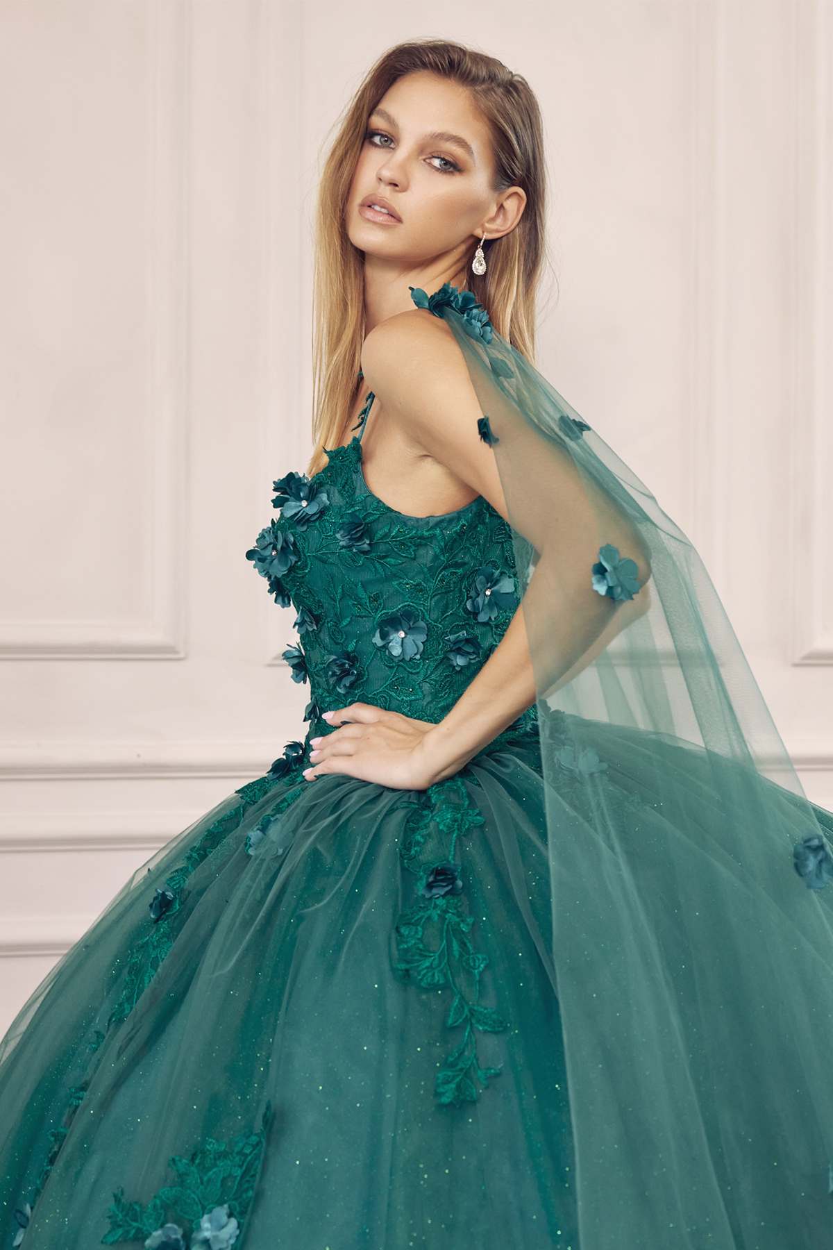 Emerald green ball gown with floral bodice embellishment, spaghetti straps, and tulle skirt