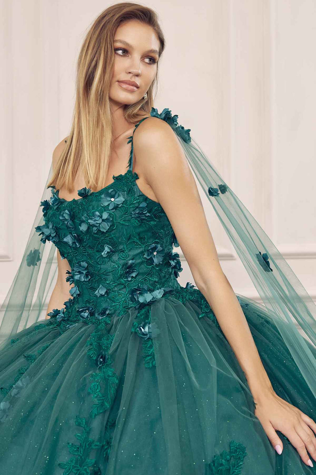 Emerald green A-line ball gown with floral applique bodice, spaghetti straps, sheer tulle overlay