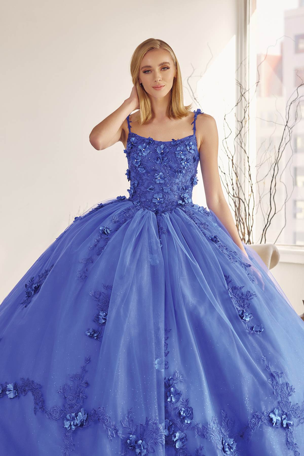 A-line ball quinceanera gown in royal blue with floral appliques, sleeveless bodice, layered tulle skirt