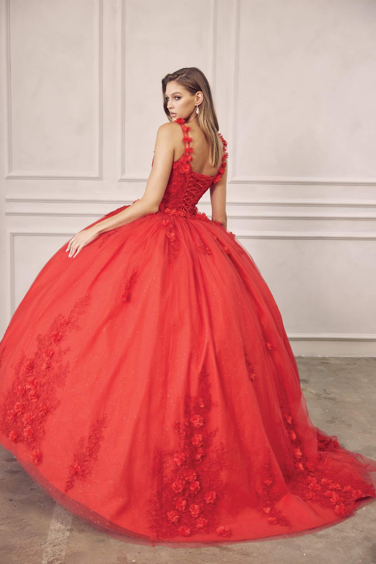Red quinceanera ball gown side view, sleeveless lace bodice with floral details