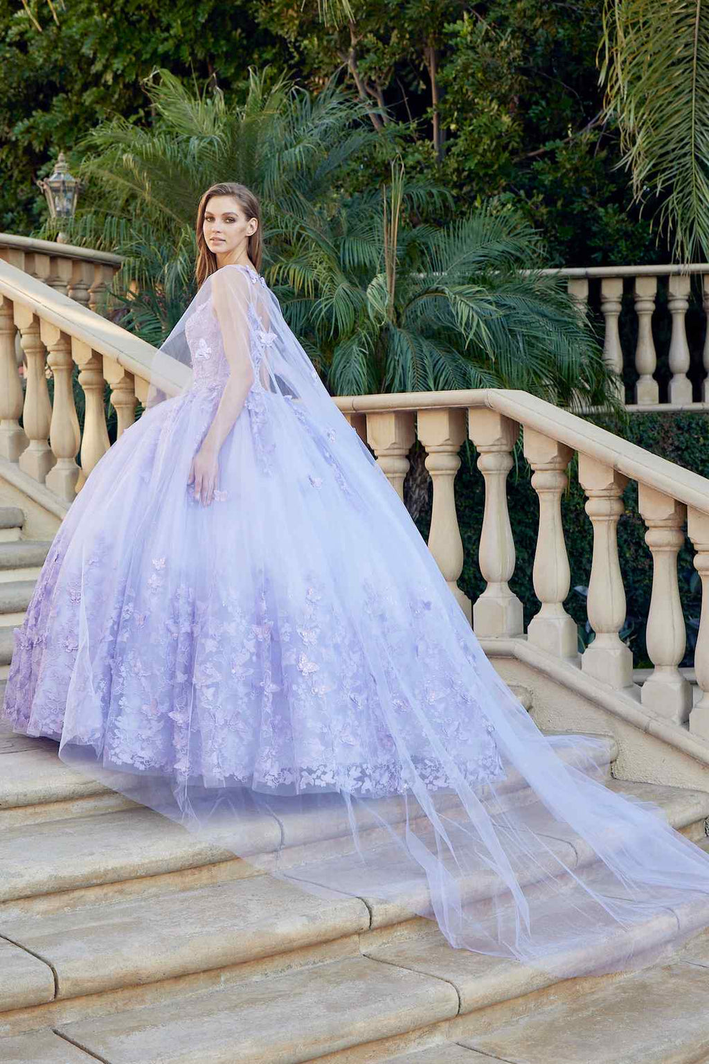 Lilac long quinceanera dress with butterfly appliques and sheer cape, flowing tulle skirt
