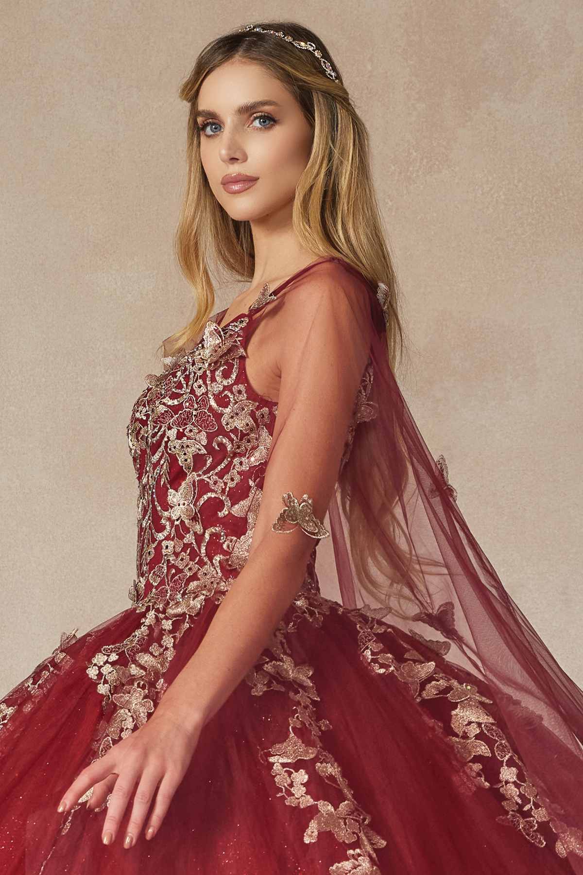 Burgundy corset-style quinceanera dress with butterfly appliques and long sheer tulle