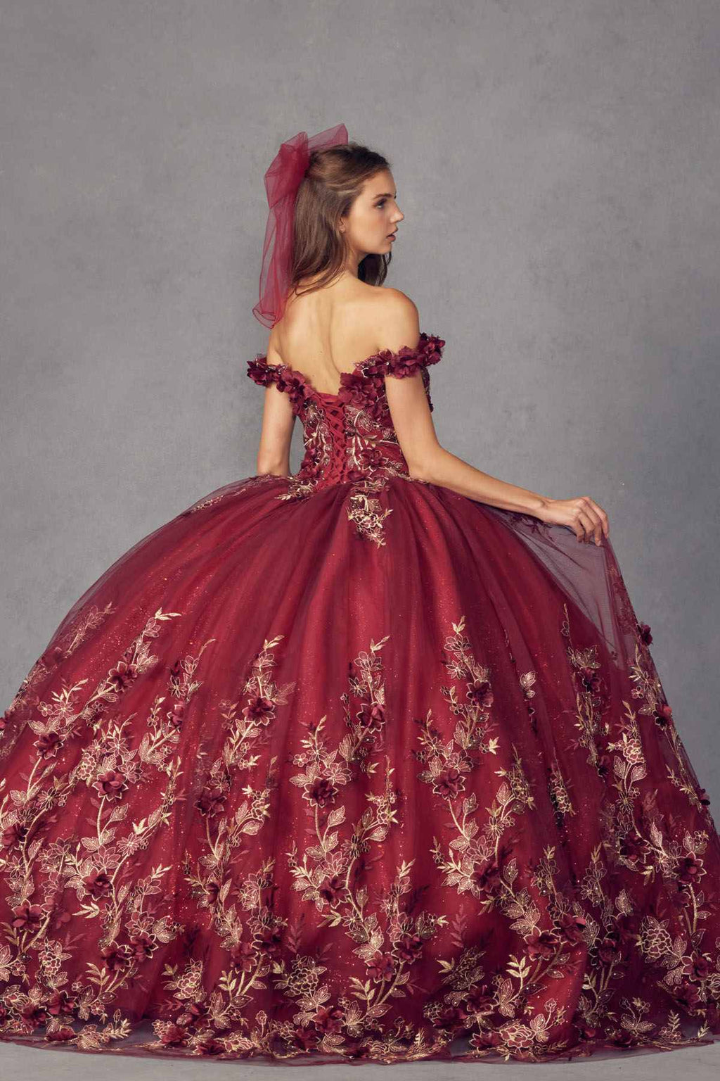 Burgundy off-shoulder ball gown with floral appliques and full skirt, side bow detail