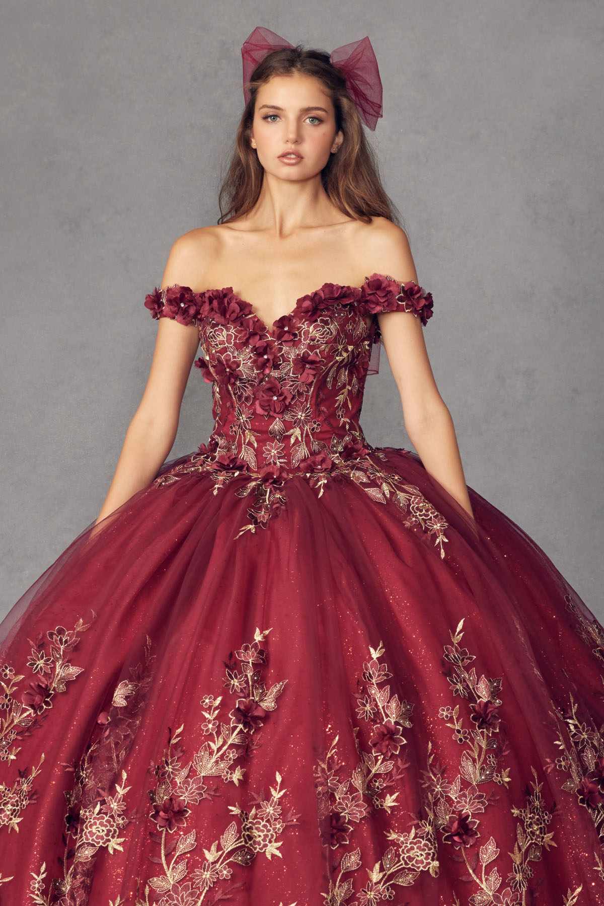 Burgundy off-shoulder ball gown with floral appliques and sweetheart bodice, bow