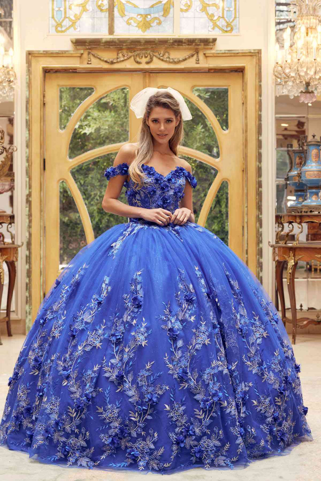 Blue off-shoulder ball gown with 3D floral appliques and structured, full skirt