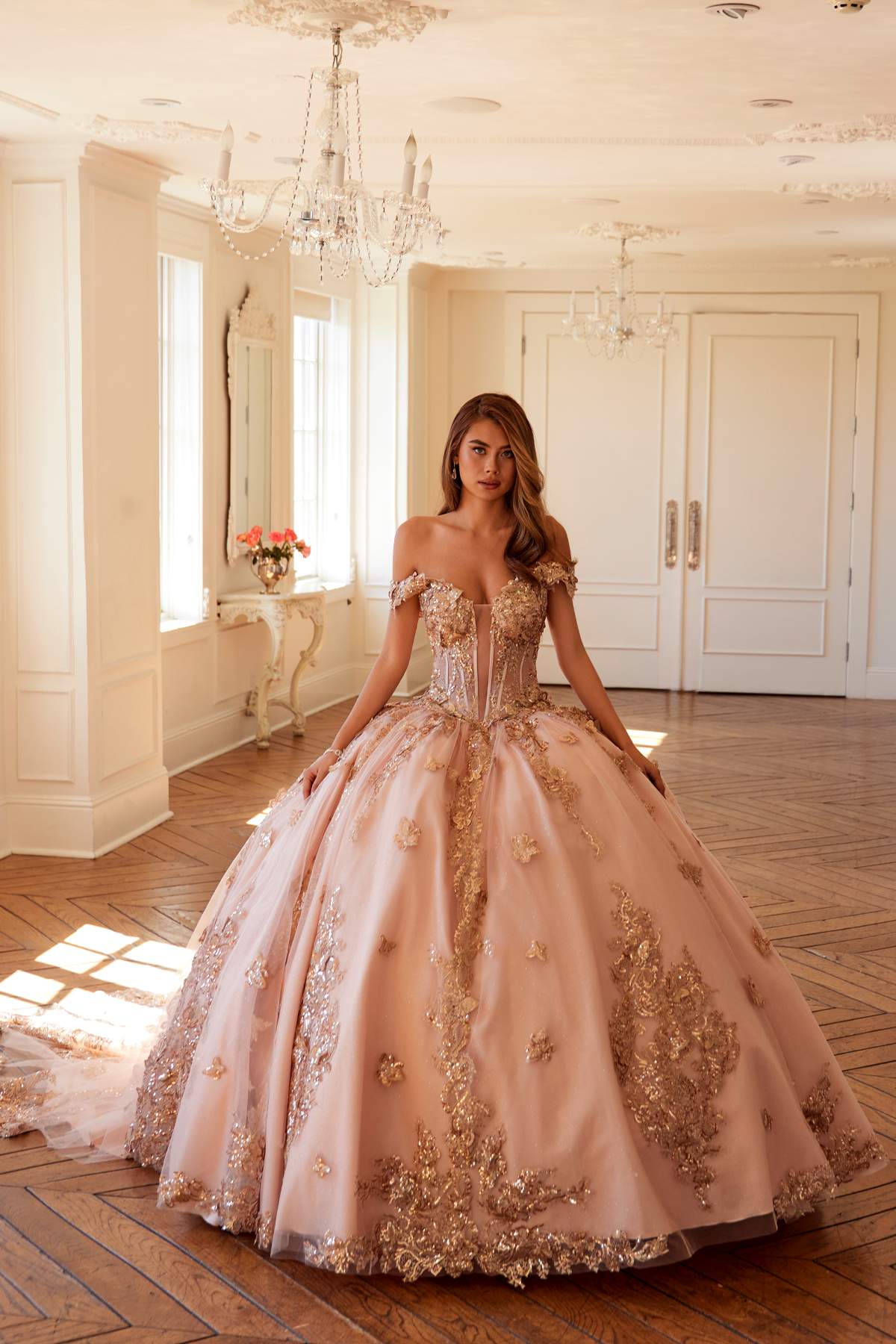 Off-shoulder blush pink ball gown with rose-gold floral embroidery, standing full view