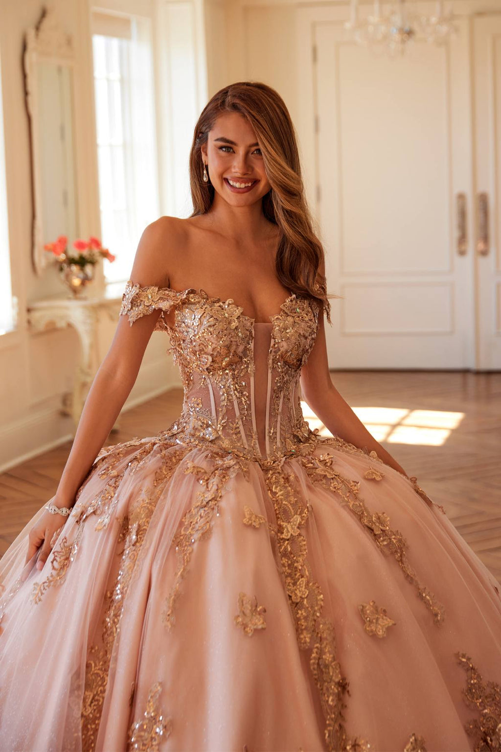 Off-shoulder blush pink corset ball gown with rose-gold embroidery, fitted bodice detail