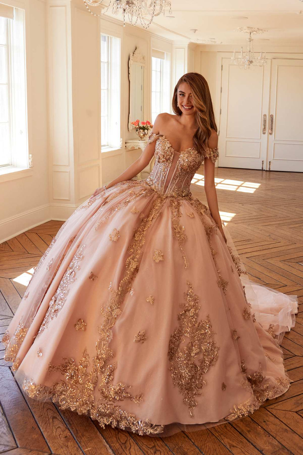 Off-shoulder blush pink ball gown with rose-gold floral embroidery and flared skirt