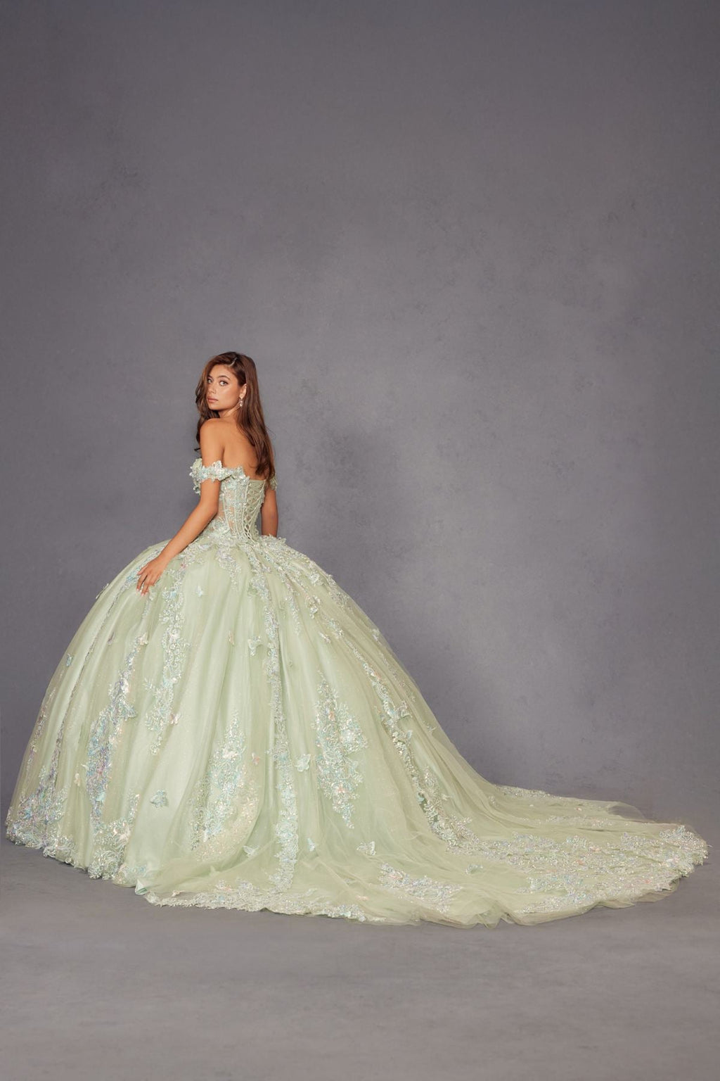 Sage green off-shoulder ball gown with embroidered skirt and long flowing train