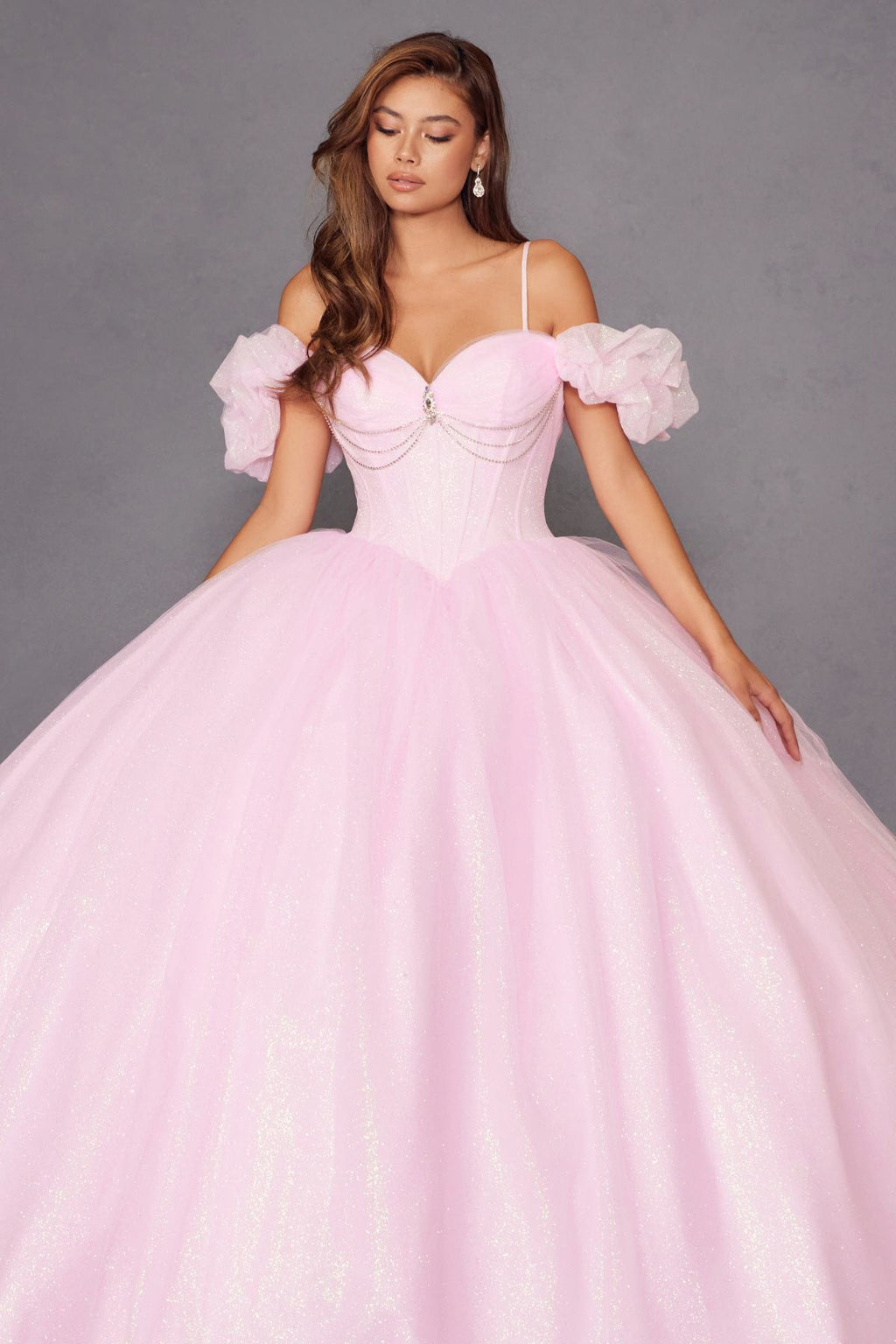 Baby pink corset ball gown with off-shoulder puff sleeves and sparkly tulle