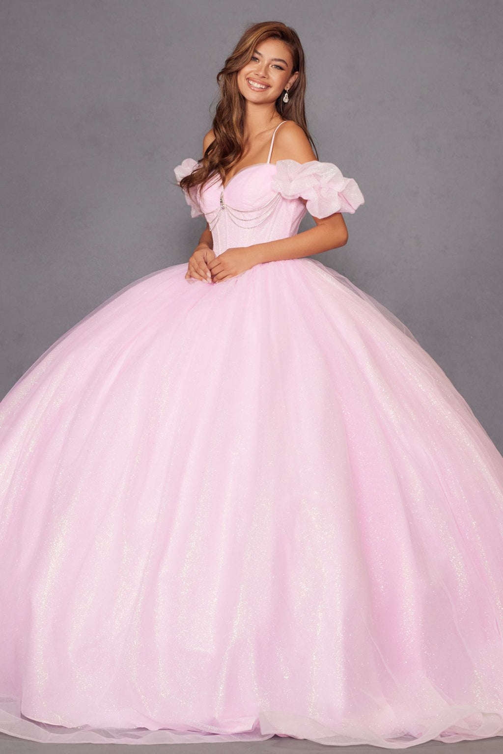 Baby pink cold-shoulder ball gown with ruffled off-shoulder sleeves and full tulle skirt