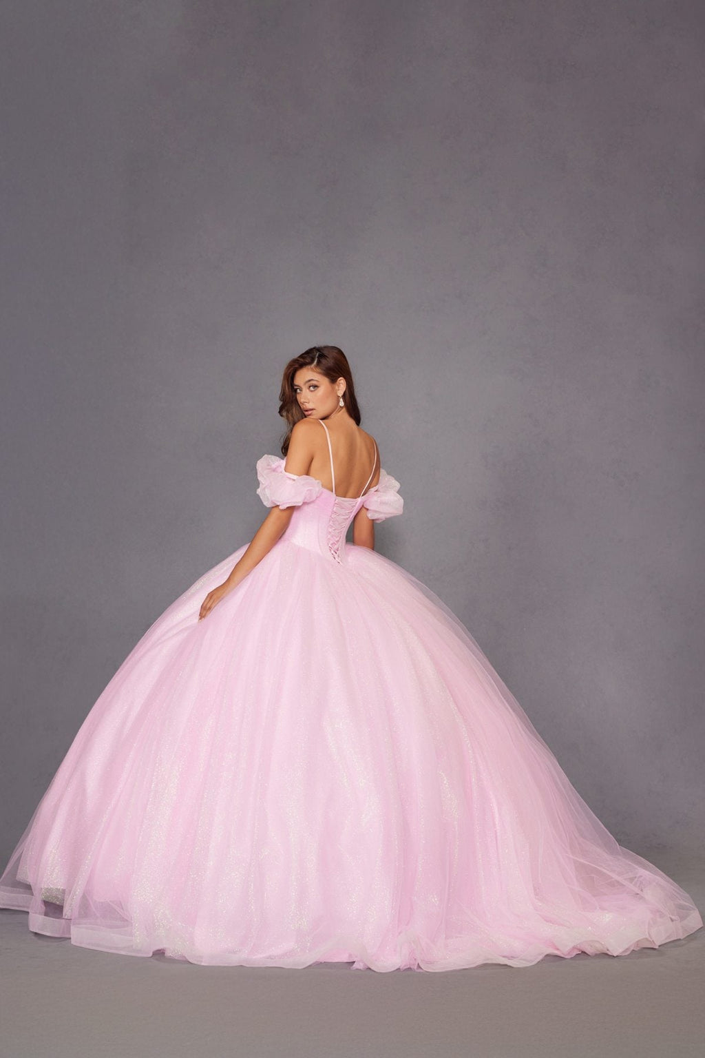 Baby pink ball gown with off-shoulder puff sleeves, full skirt, and low back