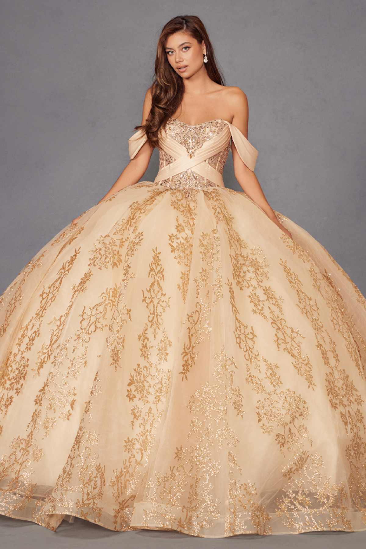 Gold quinceanera ball gown with sweetheart bodice and voluminous embroidered skirt.