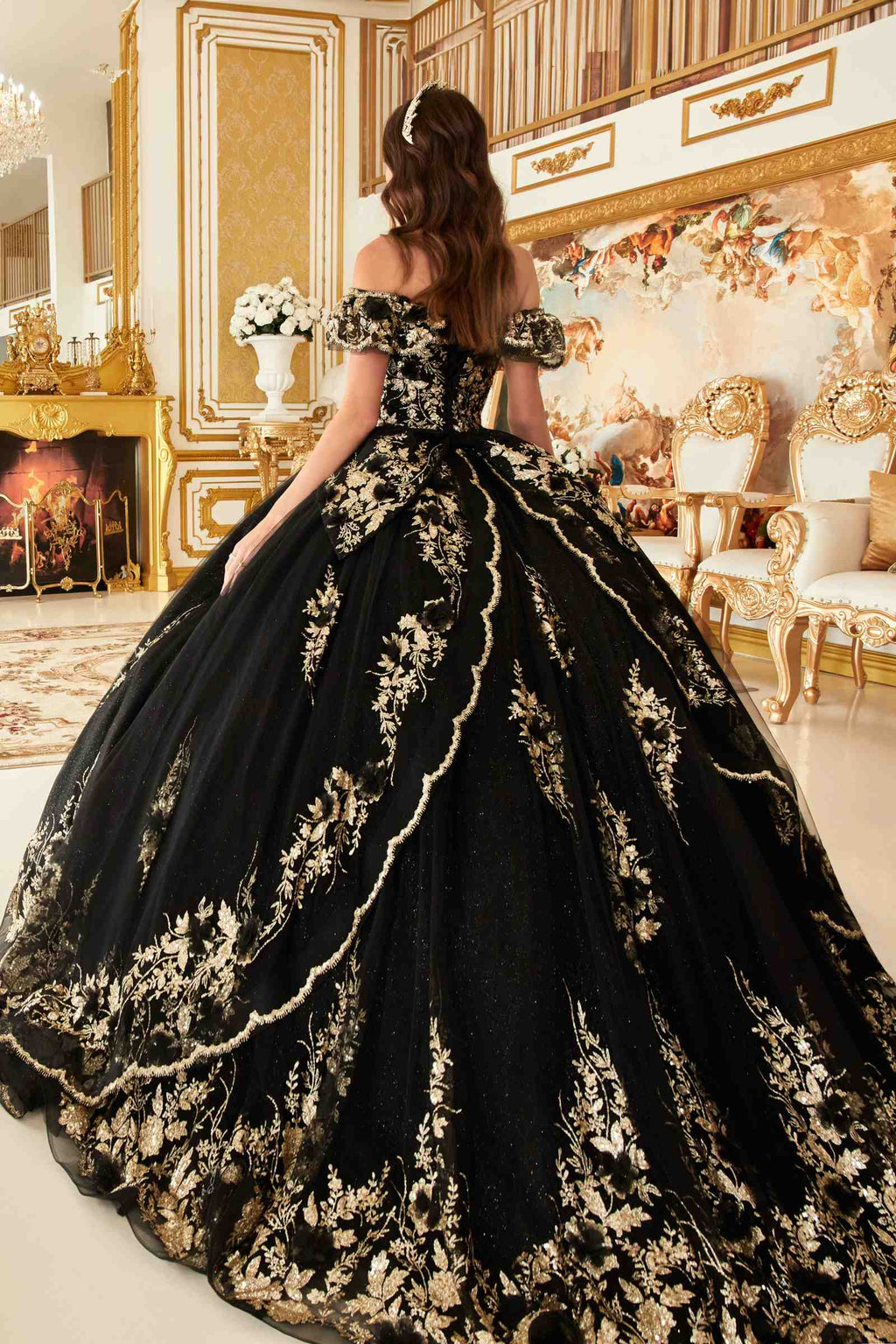 Black off-the-shoulder A-line ball gown from the back with gold floral embroidery and lace trim