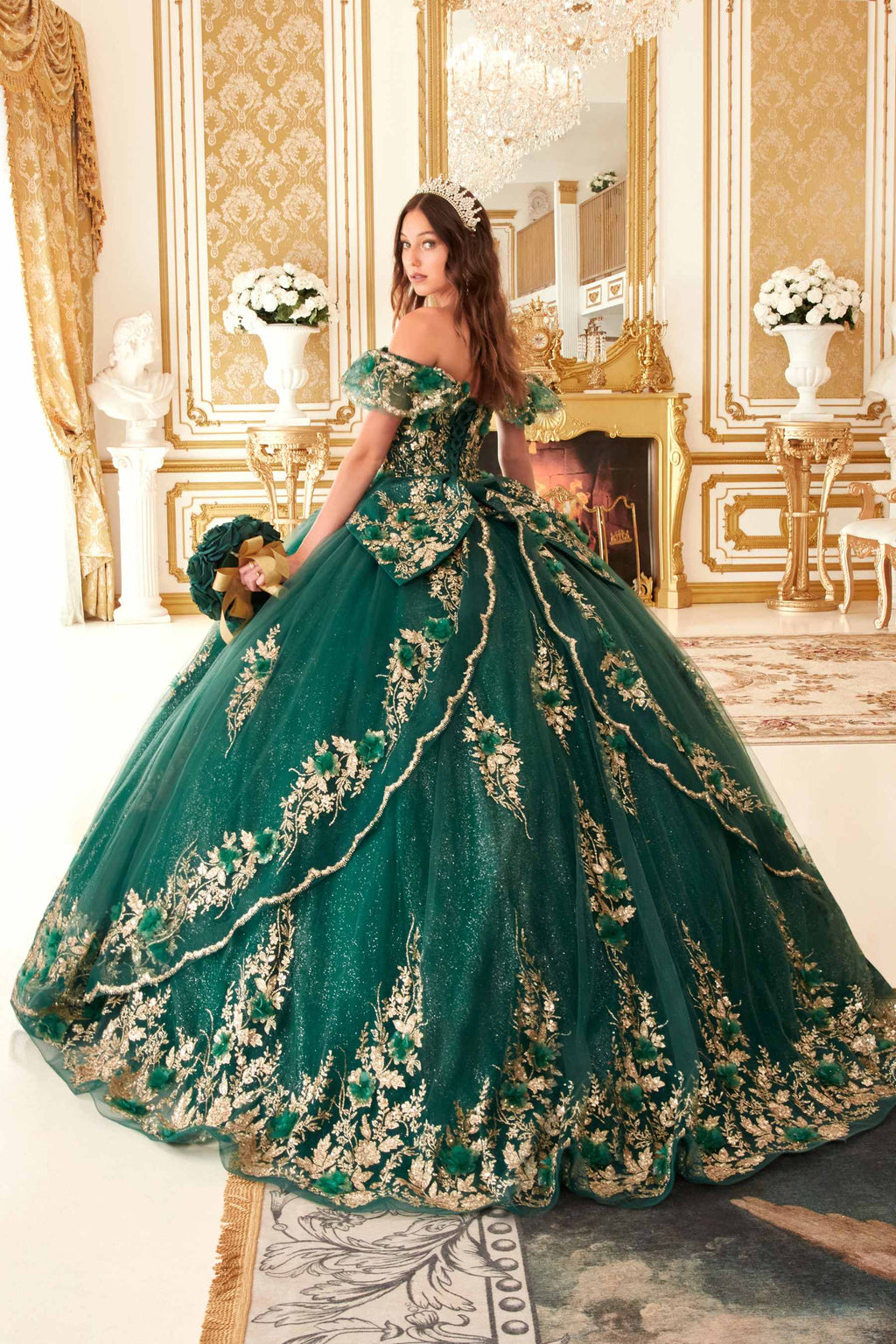 Emerald green off-the-shoulder A-line ball gown with ornate gold floral detailing and bow sleeves