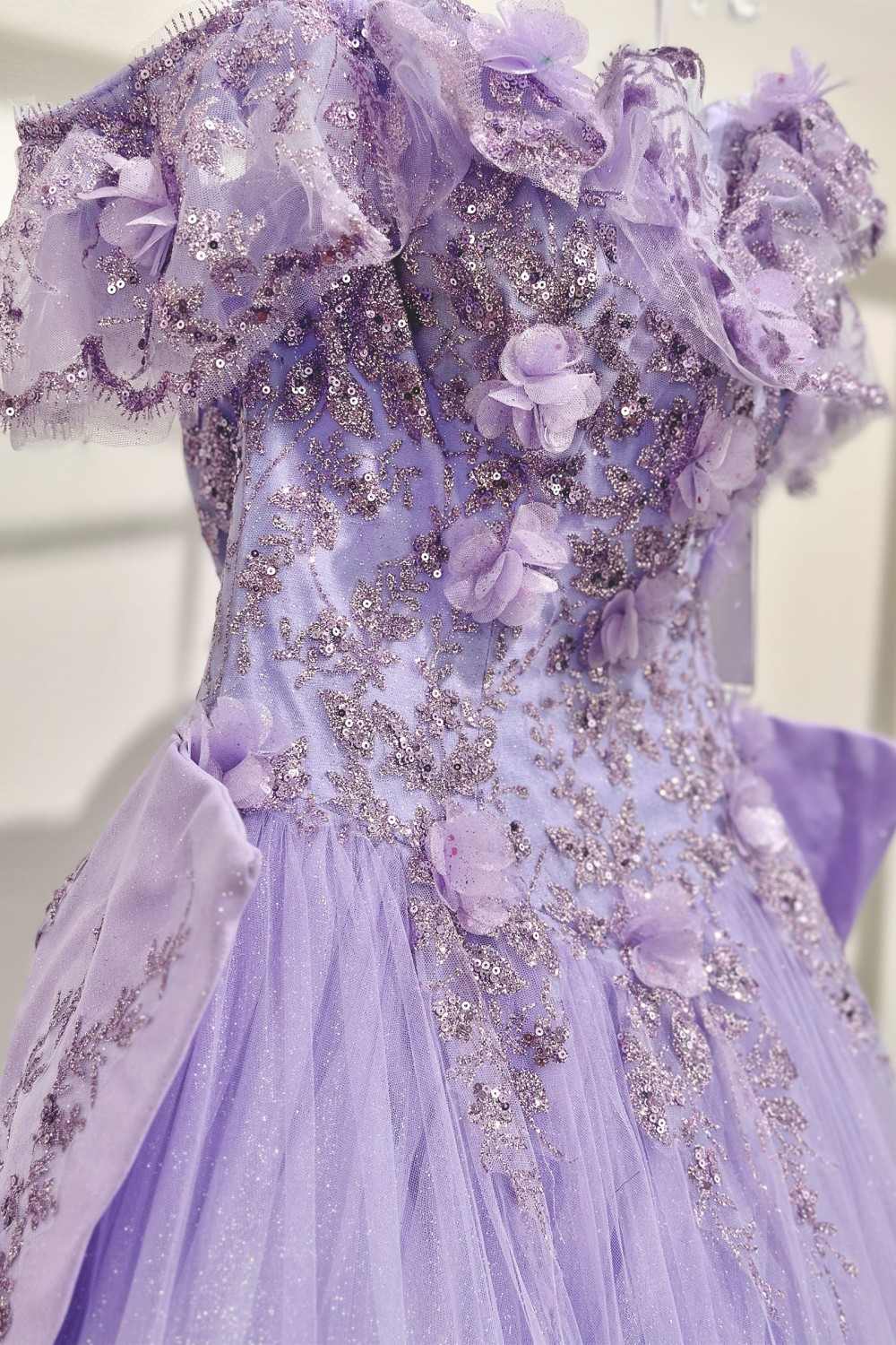 Lavender off-shoulder quince ball gown with lace sleeves and embroidered floral waist