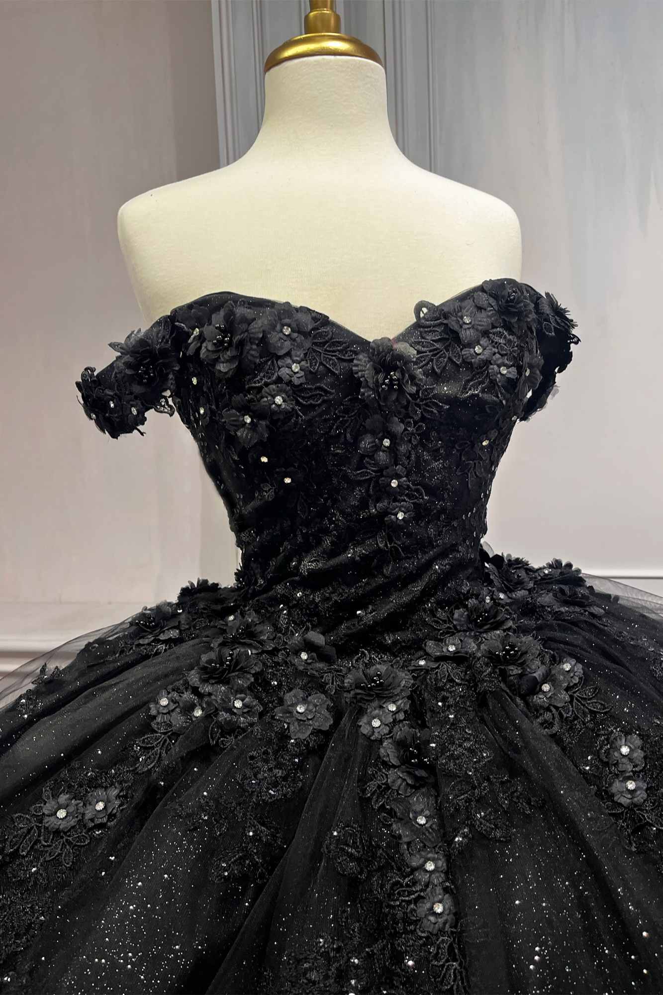 Black off-shoulder ball gown with ornate lace appliques and glitter tulle skirt