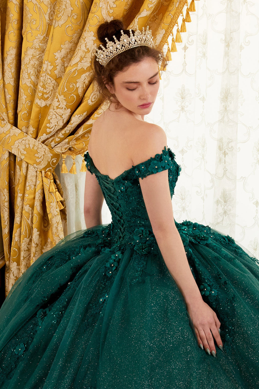 Emerald green off-shoulder ball gown with sparkling bodice and full tulle skirt