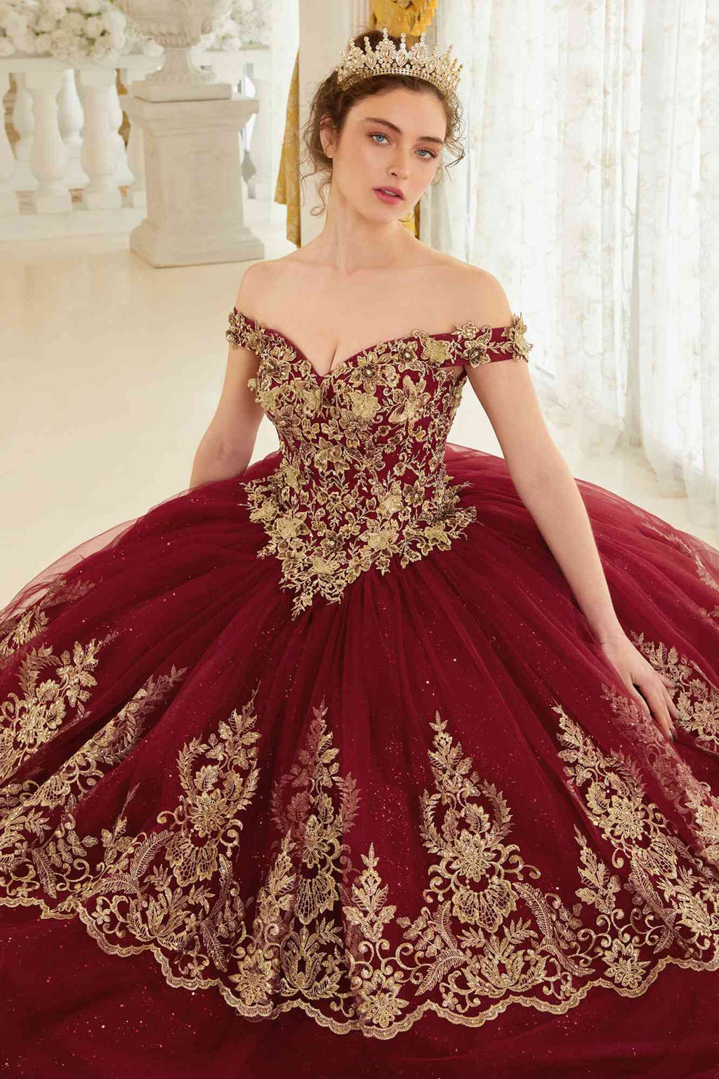 Burgundy off-shoulder ball gown with corset bodice and gold embroidery on full skirt