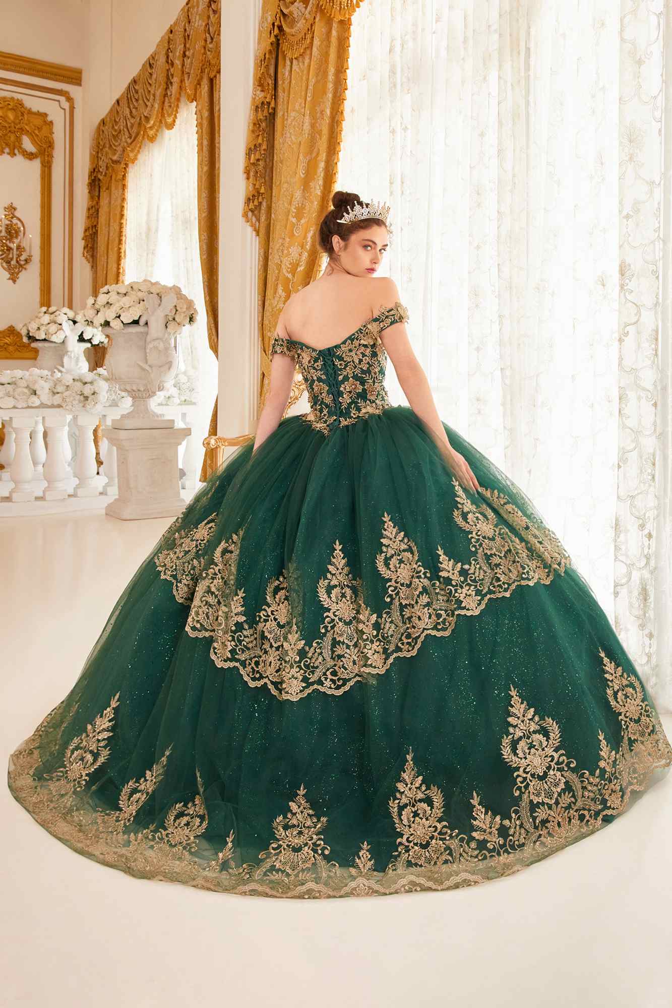 Emerald green ball gown with off-shoulder neckline and gold embroidered skirt