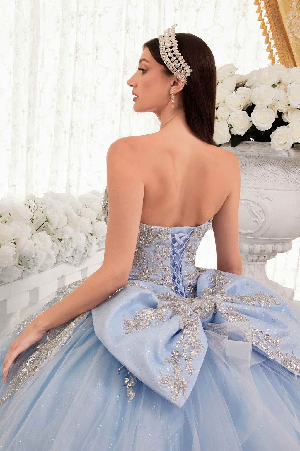 Light blue strapless backless ballgown with bow detail and gold floral appliques