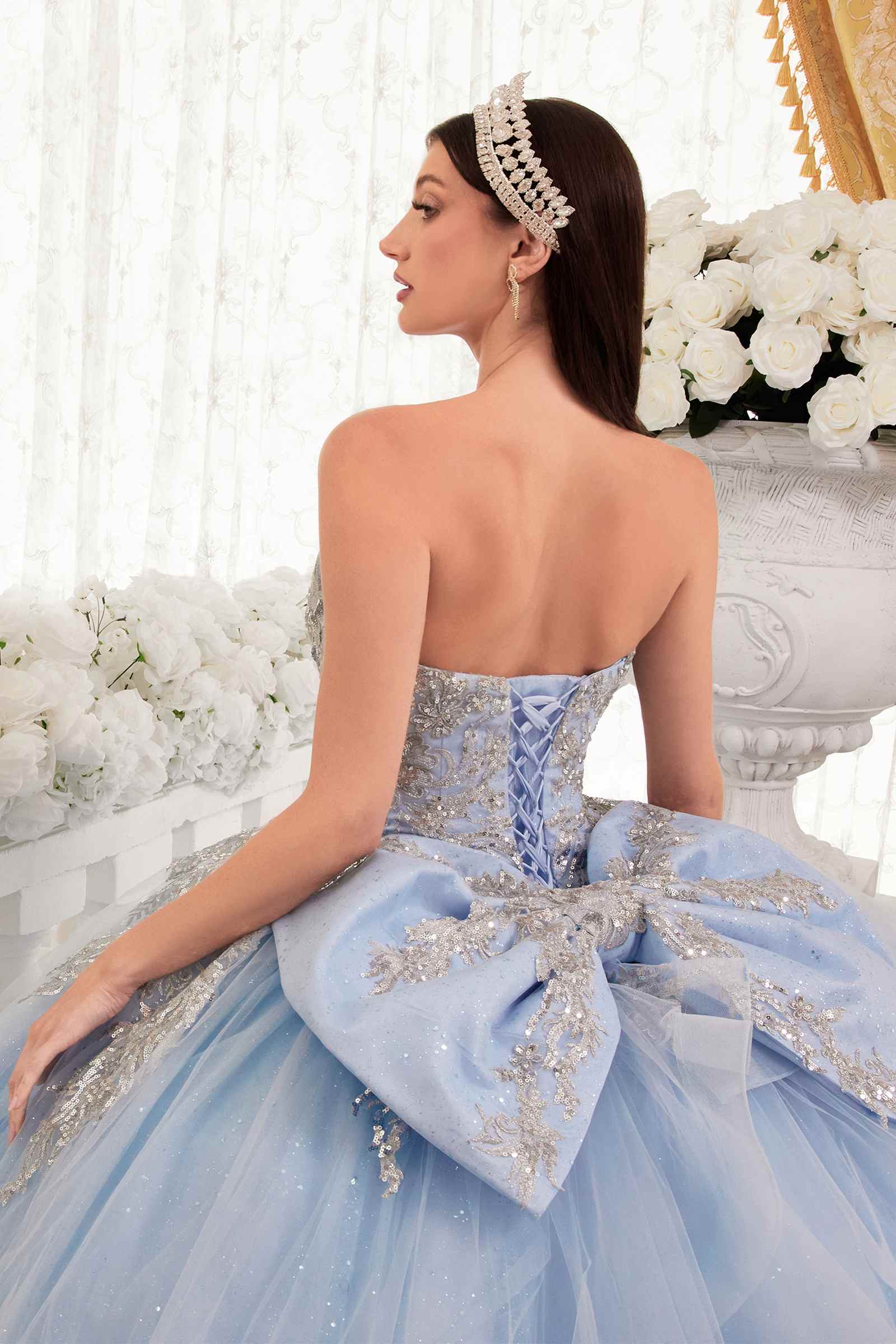 Light blue strapless backless ballgown with bow detail and gold floral appliques