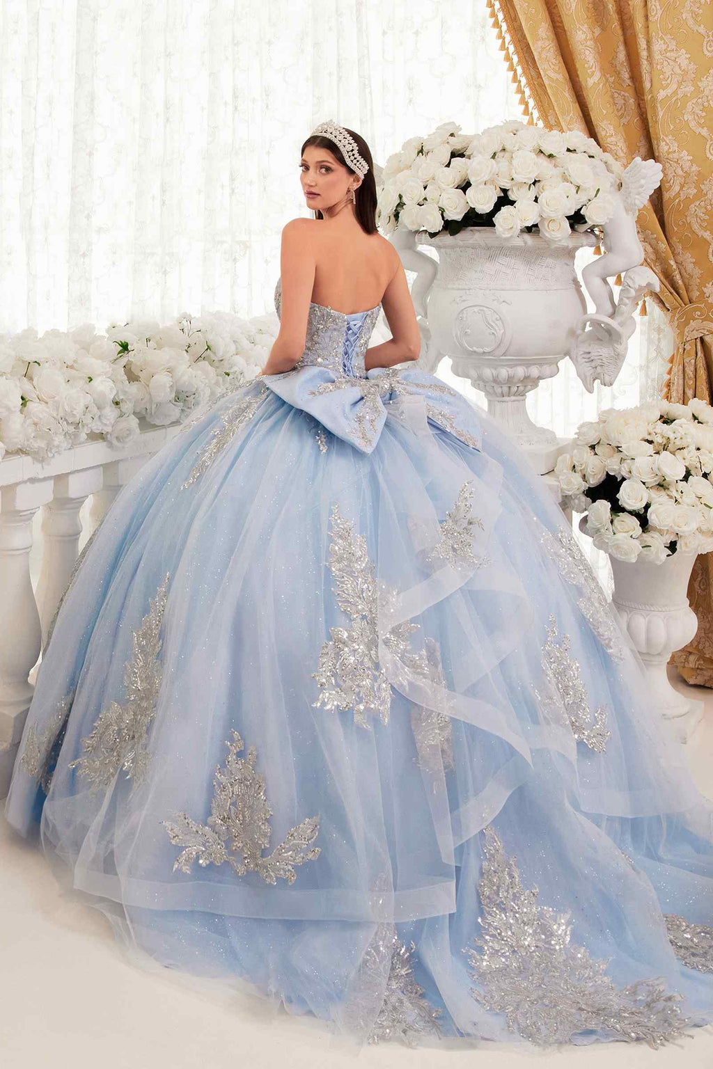 Light blue strapless ballgown with full tulle skirt and gold floral embroidery