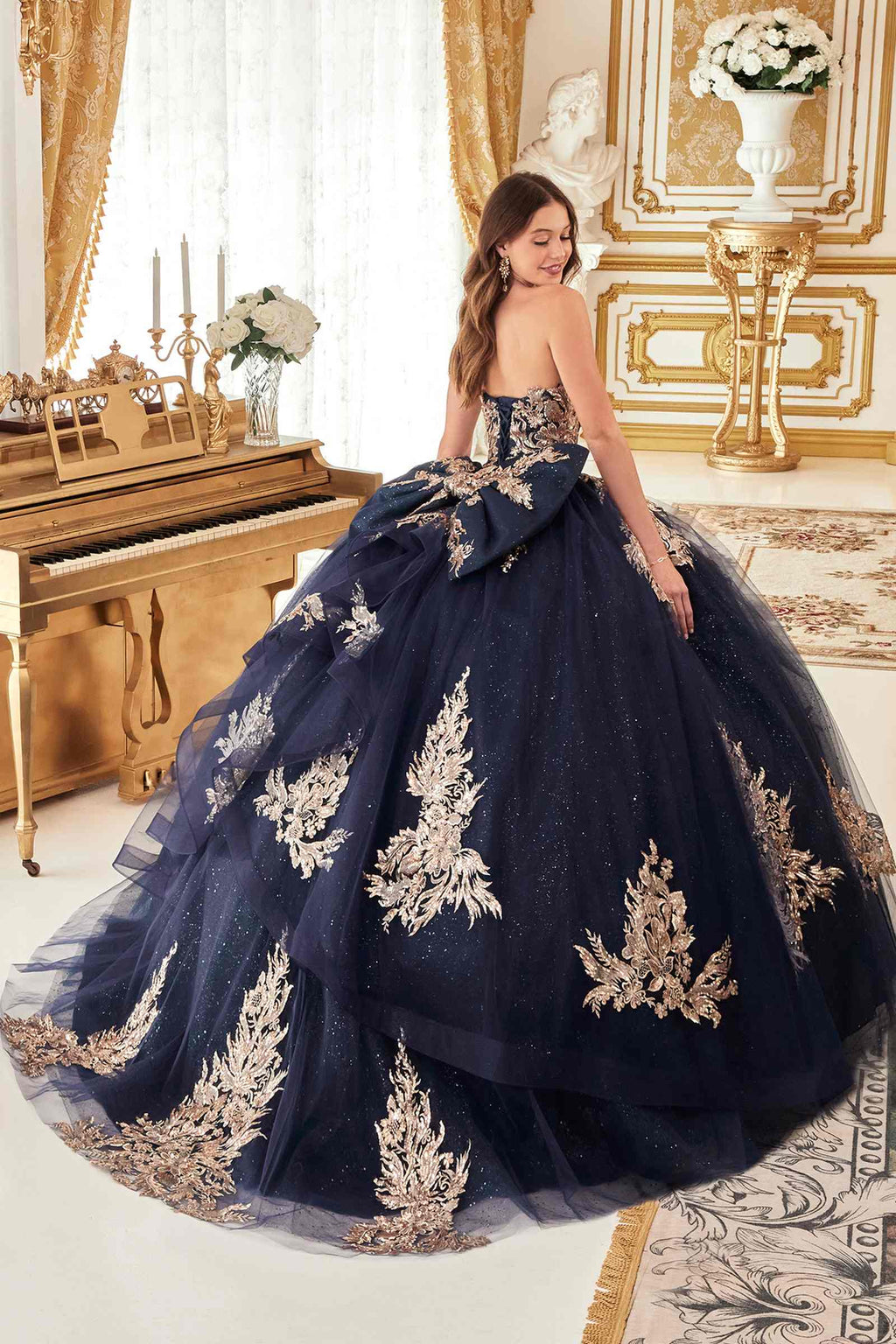 Dark navy strapless ballgown with full tulle skirt and gold floral embroidery