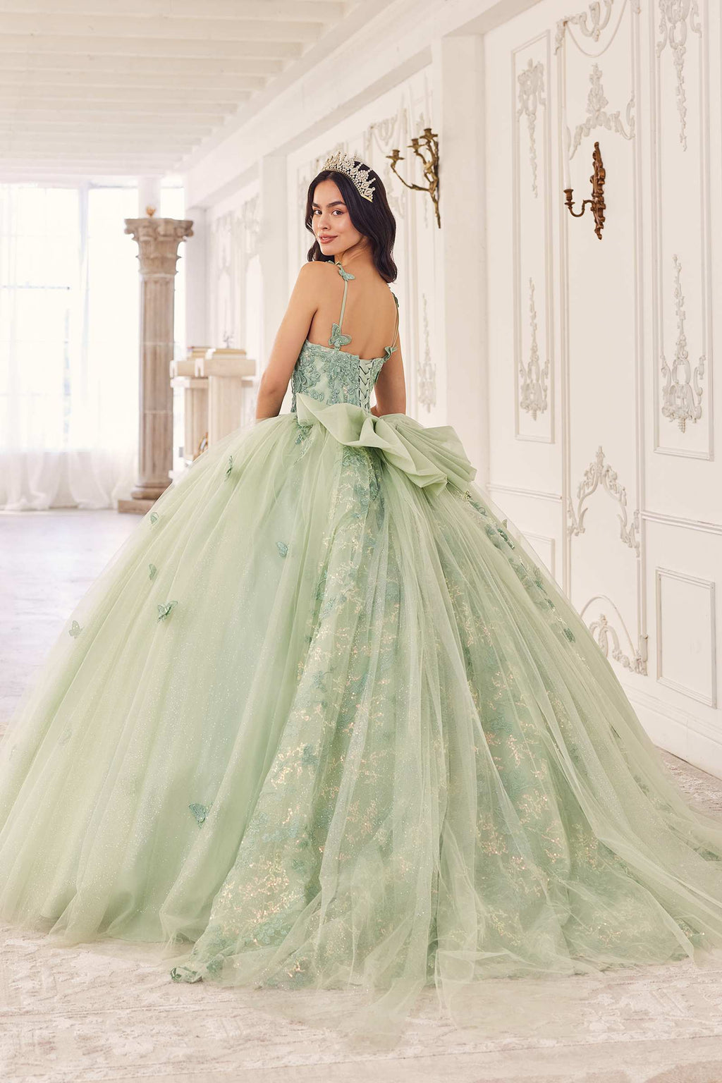 Sage green spaghetti-strap tulle ball gown with floral appliques and bow-like waist detail